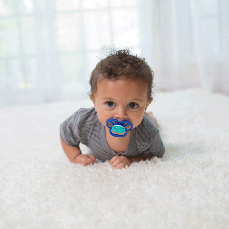 baby laying on rug